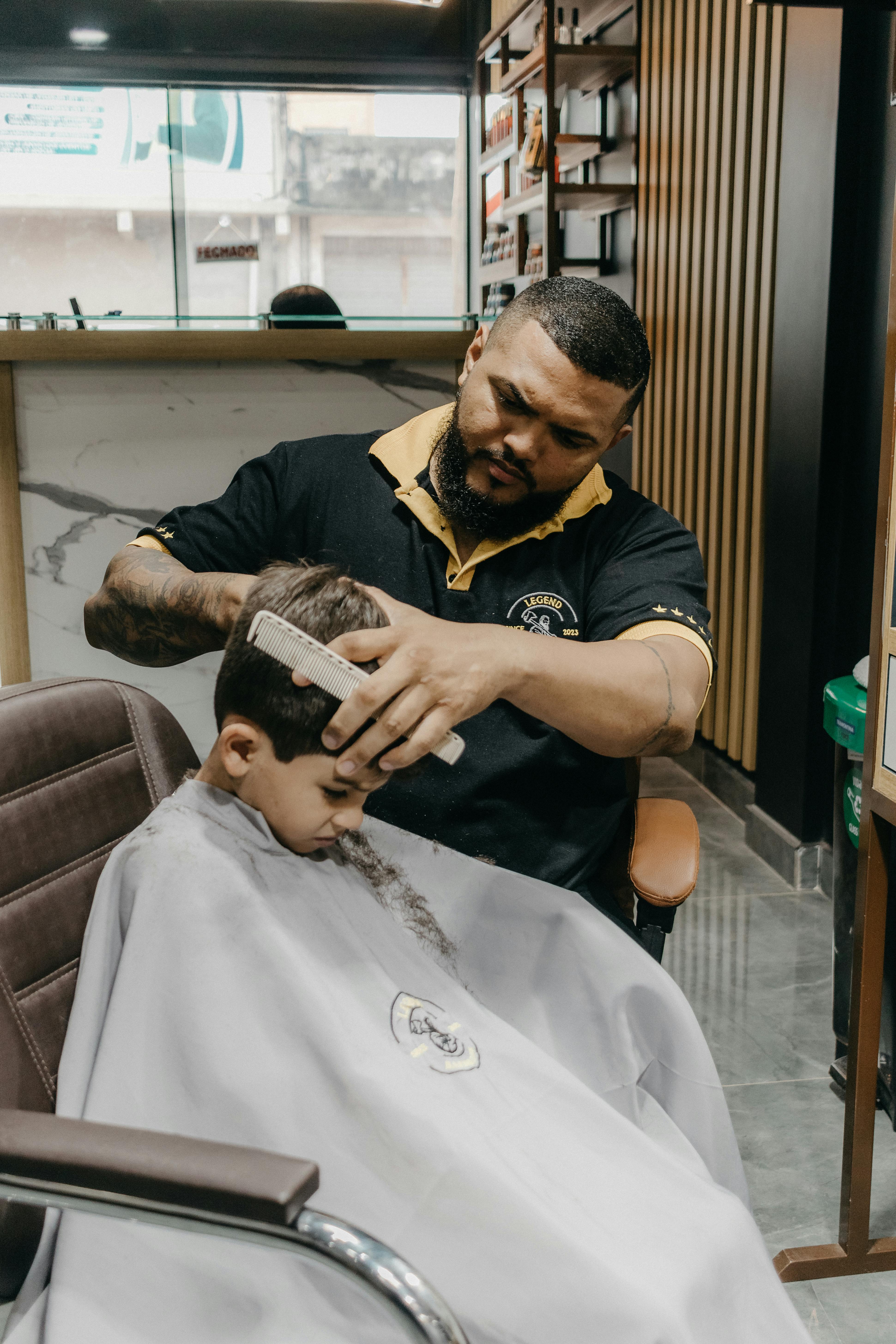 A man getting his hair cut by a barber